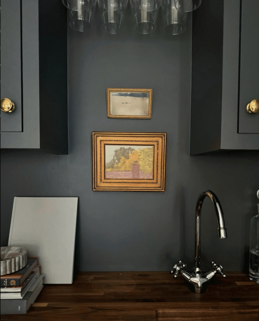 Kitchen Design featuring art hanging on the wall. Walnut countertop. Chrome faucet.