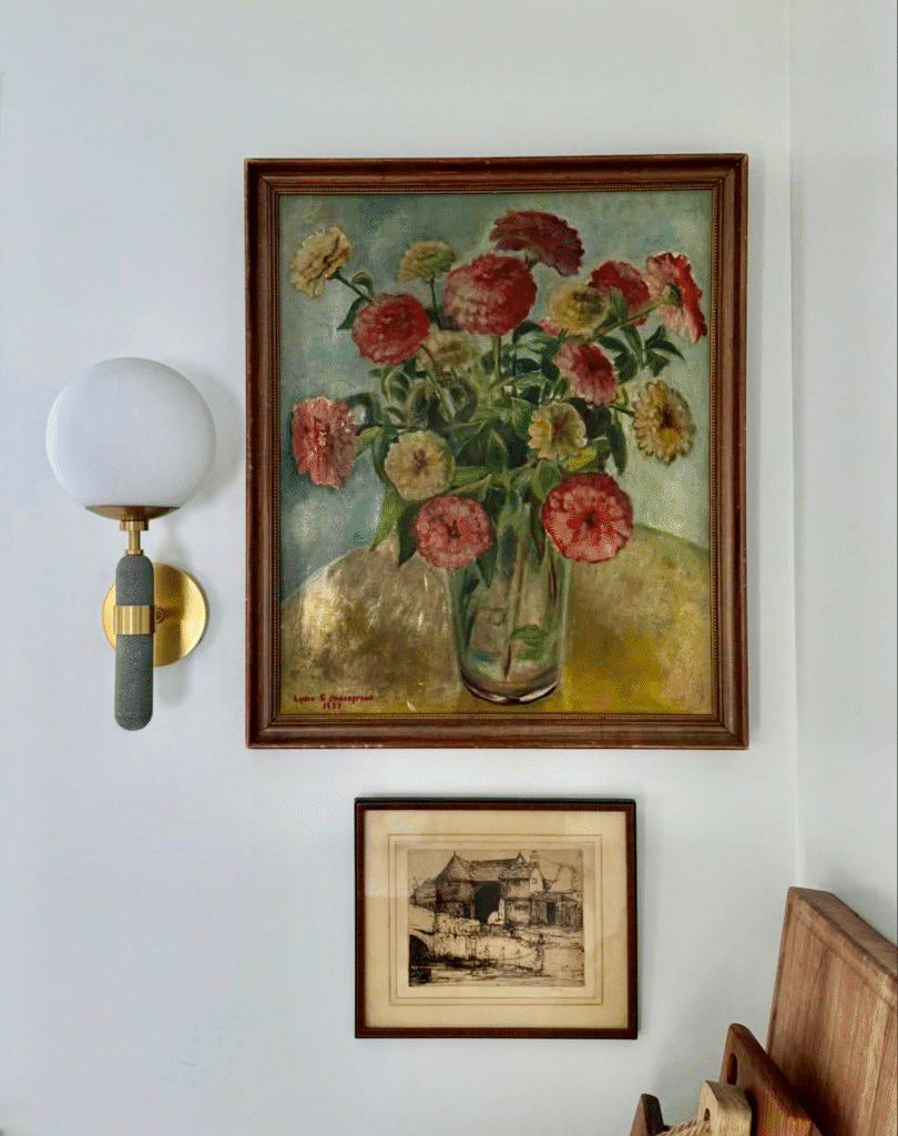 Kitchen Design featuring art hanging on the wall. Modern sconce light. Wooden cutting boards leaned against the wall.