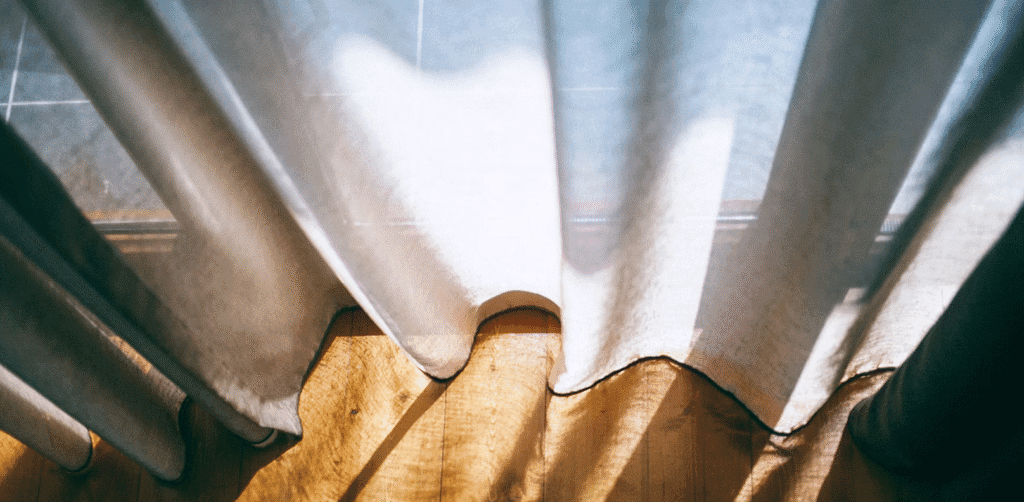 Custom curtains reaching down to wood floor.