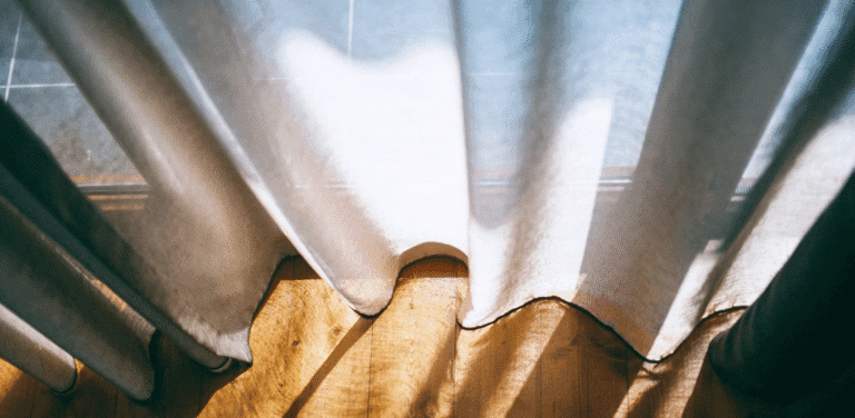 Custom curtains reaching down to wood floor.